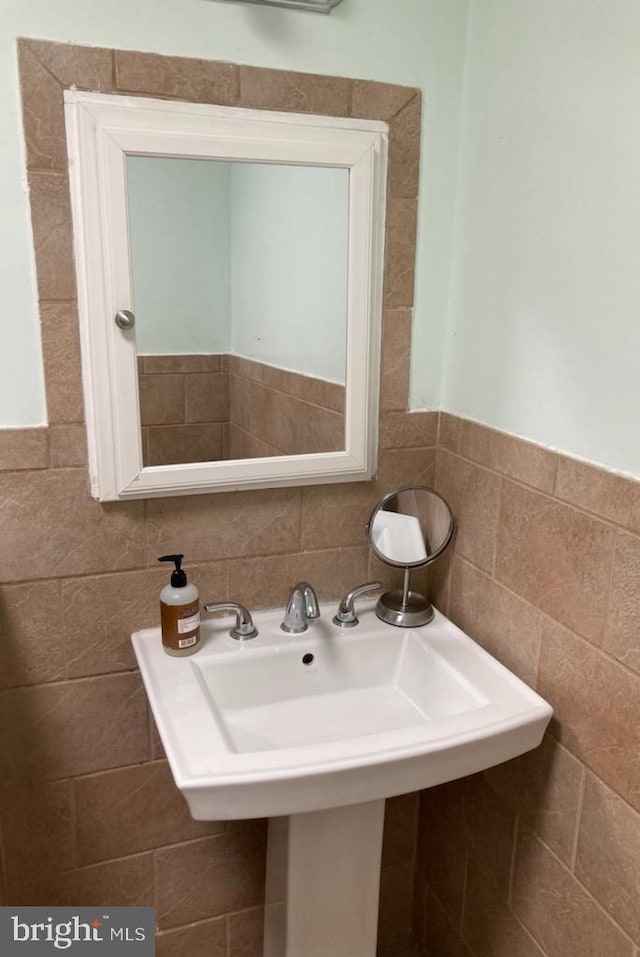 bathroom with tile walls