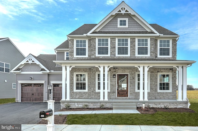 craftsman inspired home with a garage and a porch