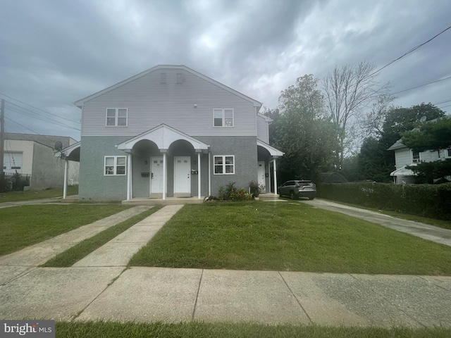 view of front of home featuring a front yard and a porch