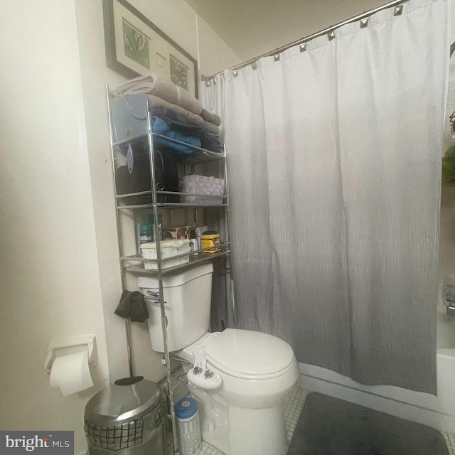 bathroom featuring toilet and tile floors