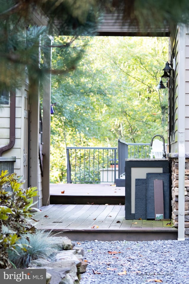 view of gate featuring a wooden deck