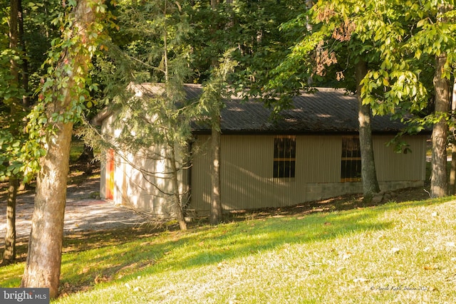 view of side of home featuring a lawn