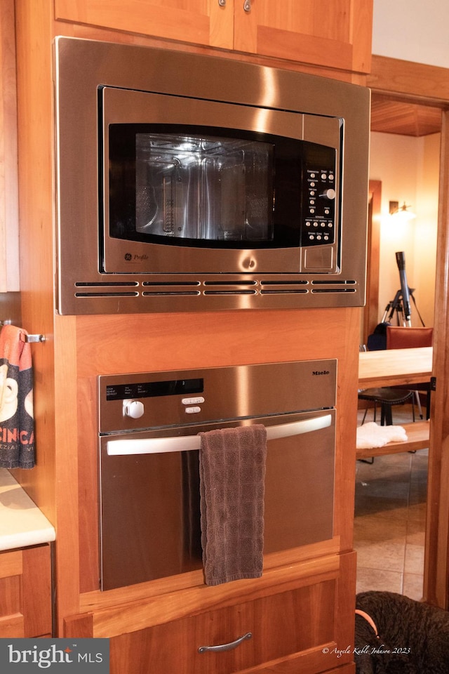 interior details with tile flooring and stainless steel appliances