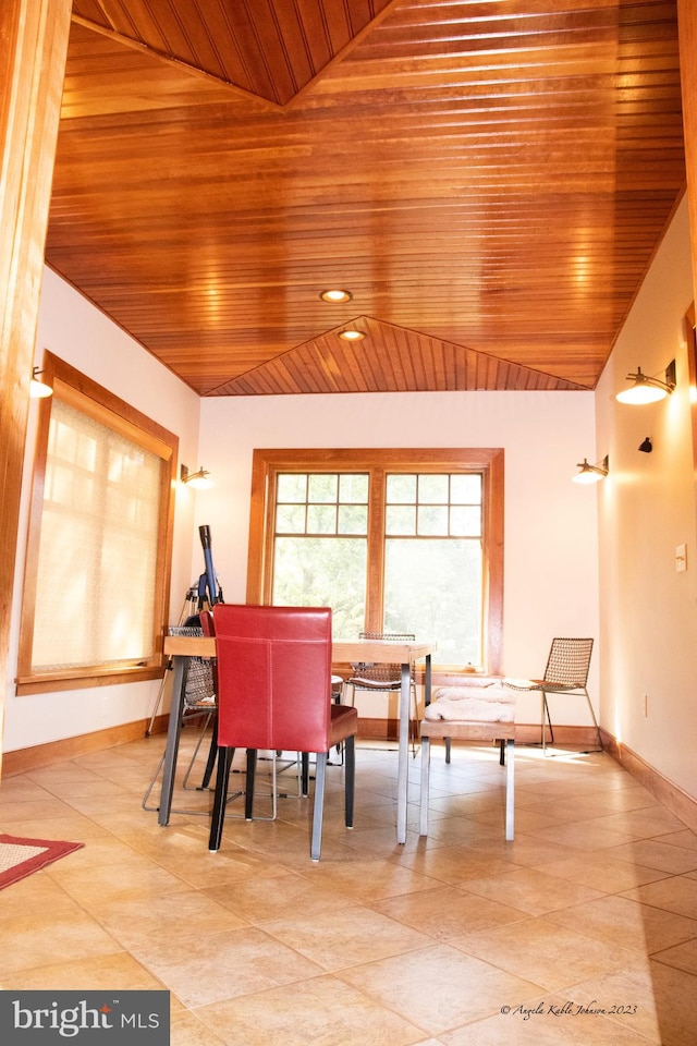 dining area featuring wooden ceiling, light tile floors, and lofted ceiling