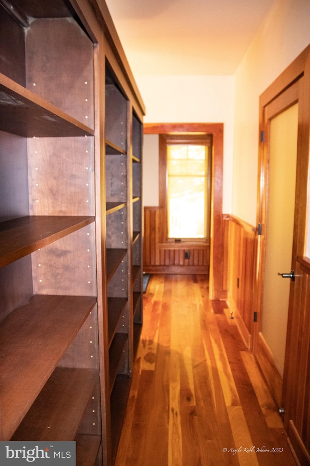 hallway with hardwood / wood-style flooring