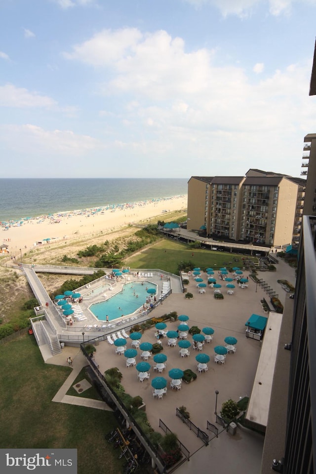 birds eye view of property with a water view and a view of the beach