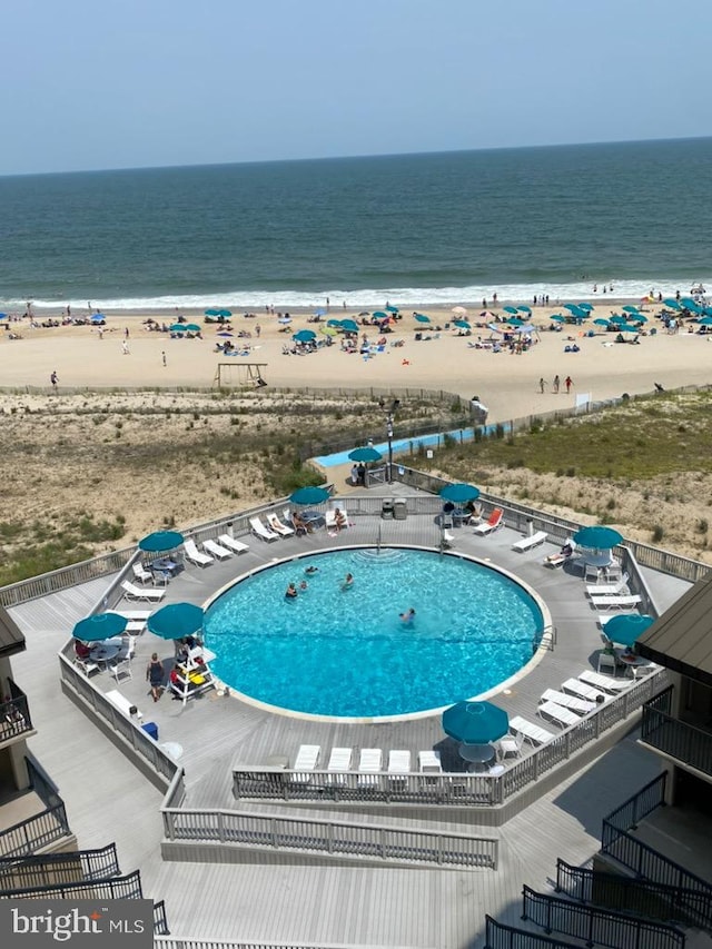 bird's eye view featuring a water view and a beach view