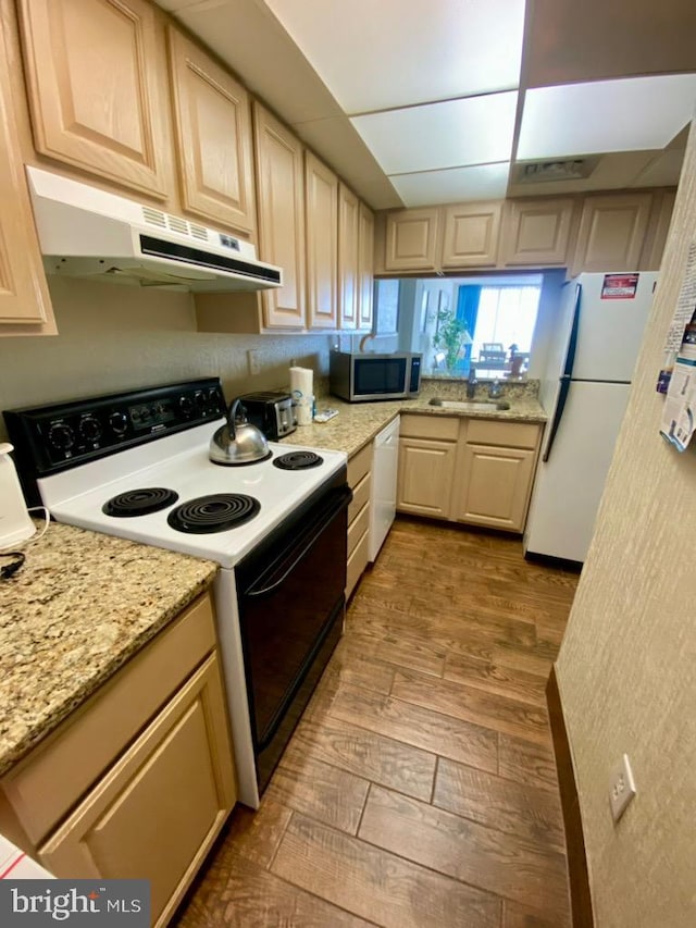 kitchen featuring white appliances, light hardwood / wood-style flooring, and light brown cabinetry