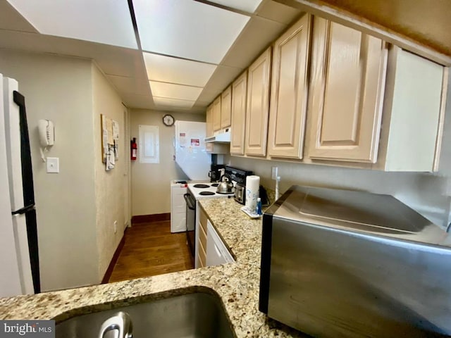 kitchen with stainless steel refrigerator, dark wood-type flooring, light stone countertops, and electric range