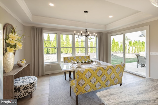 dining area featuring plenty of natural light, a notable chandelier, and light wood-type flooring