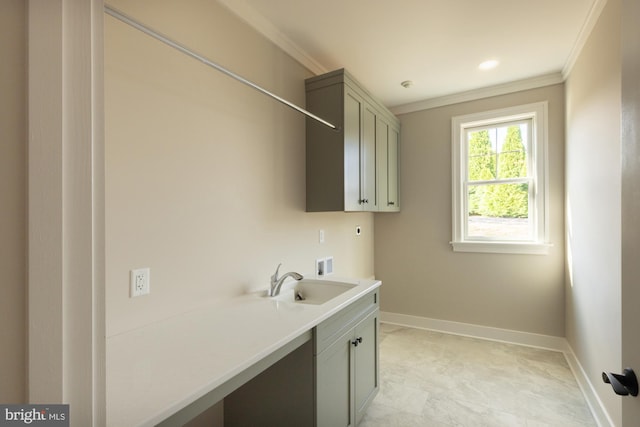 clothes washing area featuring electric dryer hookup, light tile floors, sink, cabinets, and ornamental molding