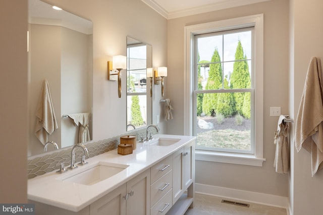 bathroom with double sink vanity, ornamental molding, tile floors, and plenty of natural light