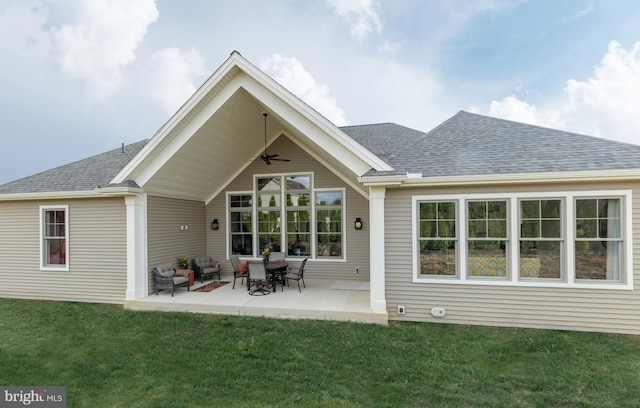 back of property with a patio, ceiling fan, and a yard