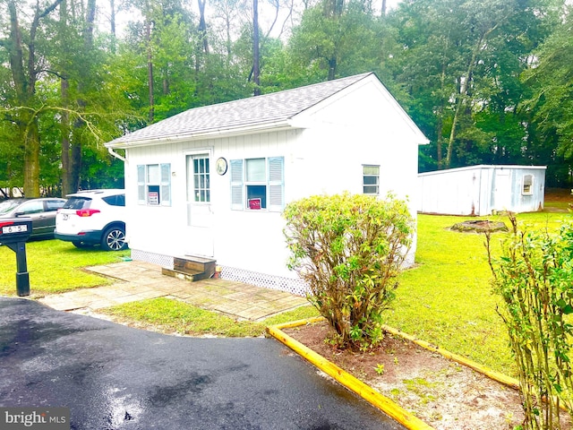 view of property exterior with a storage shed and a yard