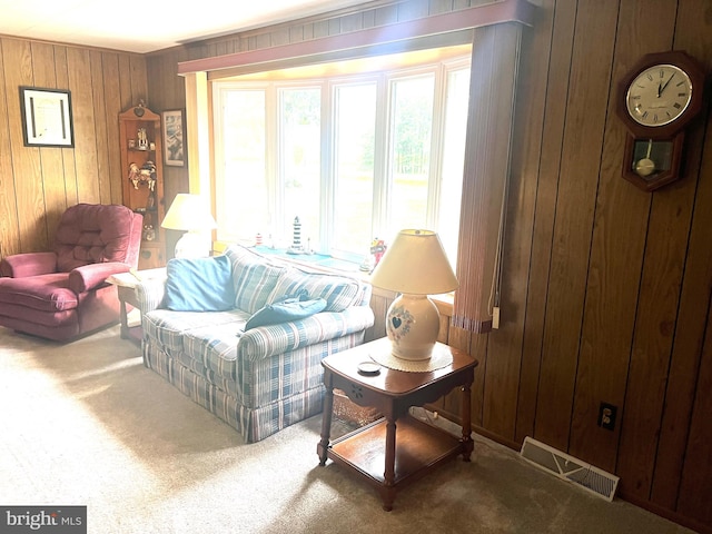 living room featuring wood walls and carpet floors