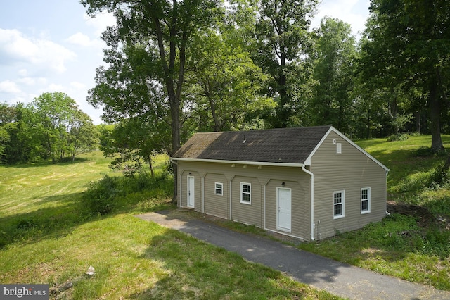 exterior space with a yard and a garage