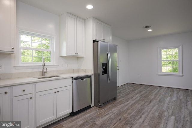 kitchen with white cabinets, dark wood-type flooring, sink, and stainless steel appliances