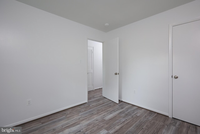 unfurnished bedroom with wood-type flooring