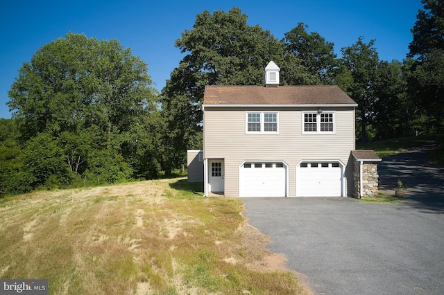 view of side of home featuring a garage