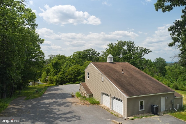 exterior space featuring central AC and a garage