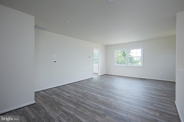 spare room featuring dark hardwood / wood-style flooring