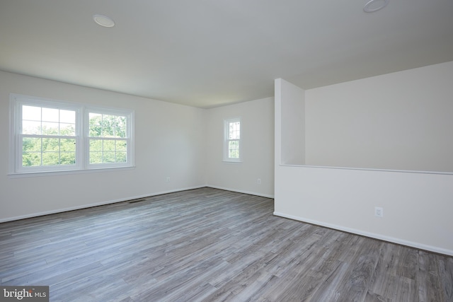 unfurnished room with light wood-type flooring