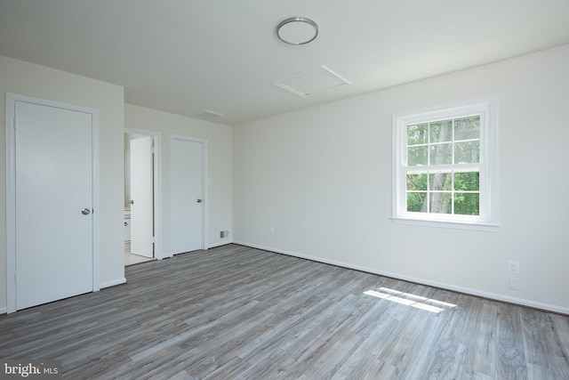 unfurnished room with hardwood / wood-style floors