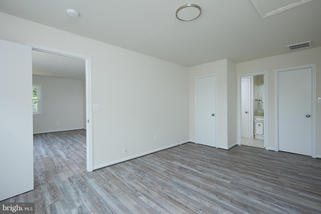 interior space featuring ensuite bath and wood-type flooring