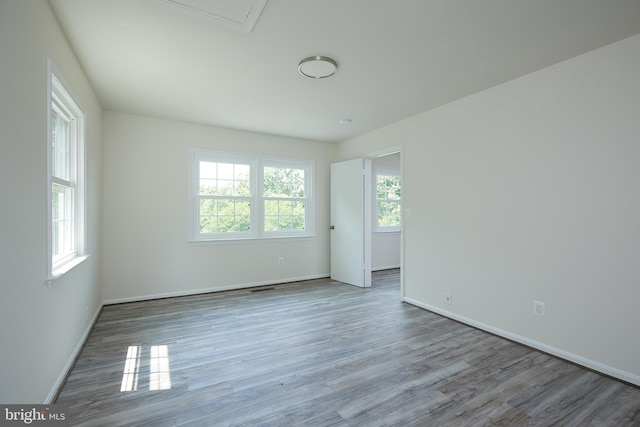 unfurnished room featuring hardwood / wood-style flooring and plenty of natural light