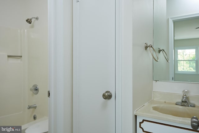 full bathroom with toilet, vanity, and shower / tub combination