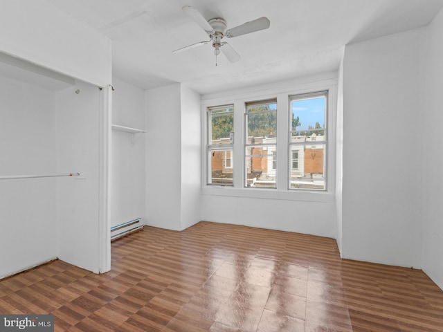 unfurnished room with a baseboard radiator, ceiling fan, and dark hardwood / wood-style flooring