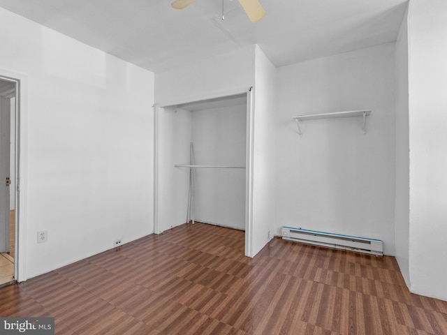 interior space featuring a baseboard radiator, ceiling fan, and dark tile floors