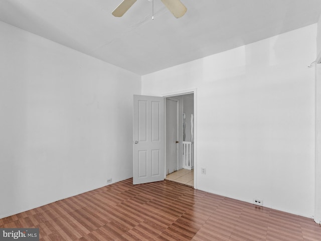 tiled empty room with ceiling fan