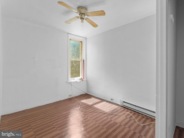 spare room with ceiling fan, baseboard heating, and dark hardwood / wood-style floors