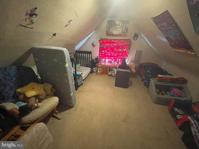 bedroom with carpet flooring, a textured ceiling, and vaulted ceiling