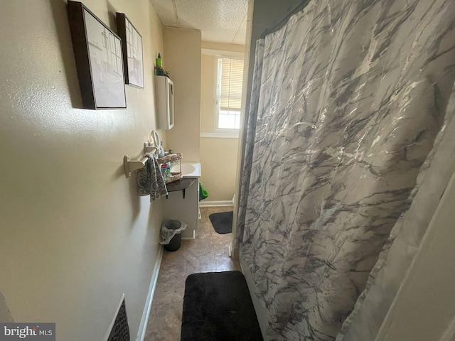 bathroom featuring vanity and a textured ceiling