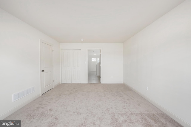 unfurnished bedroom with light colored carpet