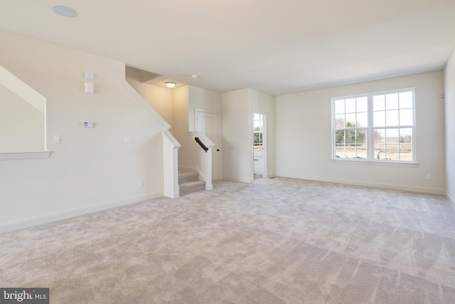 unfurnished living room with light colored carpet