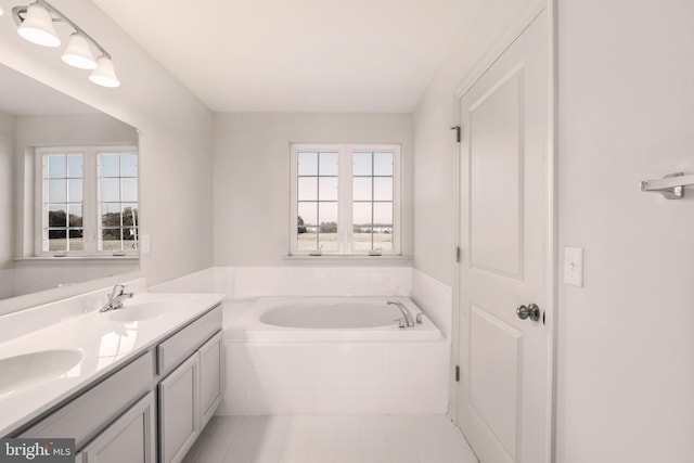 bathroom featuring double sink vanity, a relaxing tiled bath, and tile floors