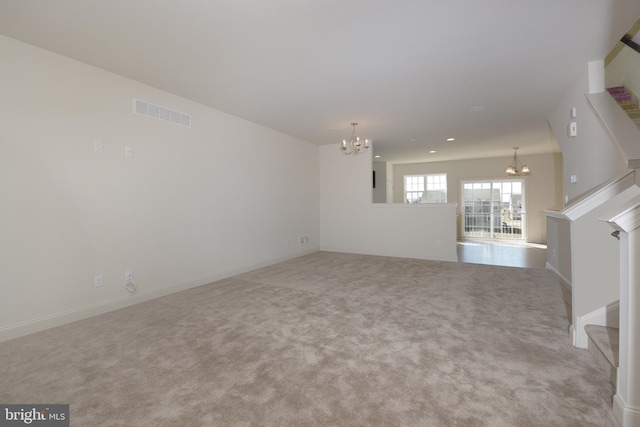 interior space featuring light carpet and an inviting chandelier