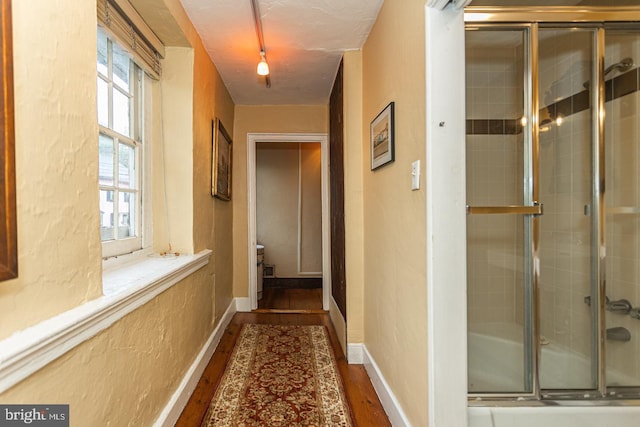 corridor featuring dark hardwood / wood-style flooring