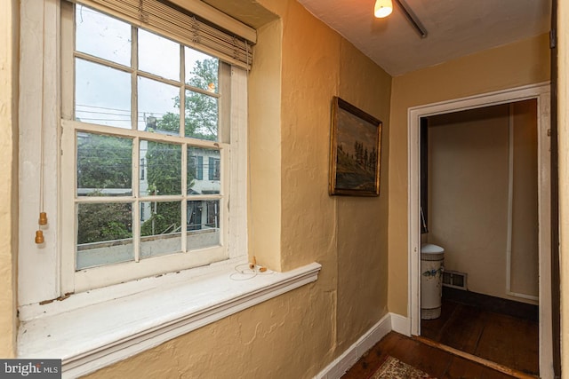 hallway with dark hardwood / wood-style flooring