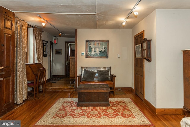 living room with track lighting and dark hardwood / wood-style flooring