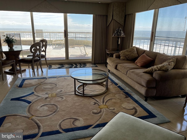 tiled living room with a water view