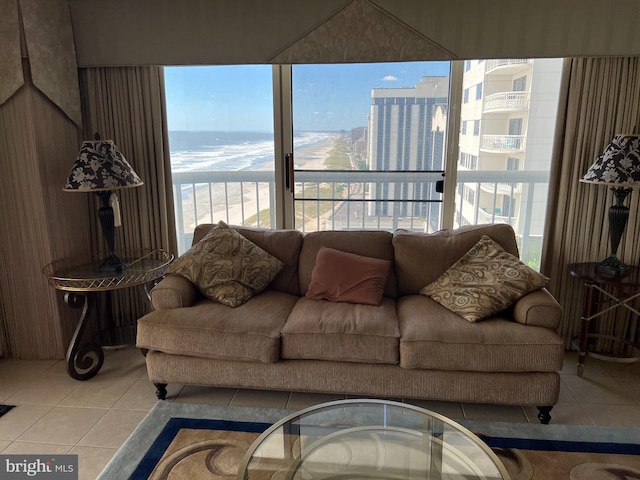 living room featuring a water view, plenty of natural light, and light tile patterned floors