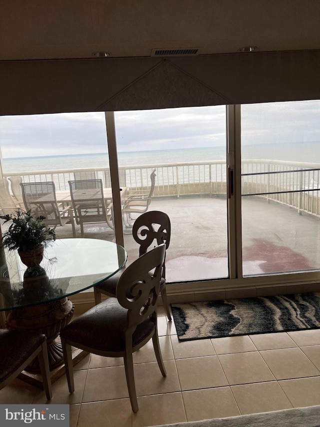 interior space with a balcony and a water view