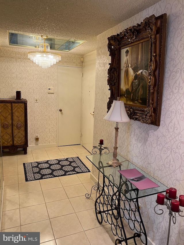 tiled foyer entrance featuring a textured ceiling