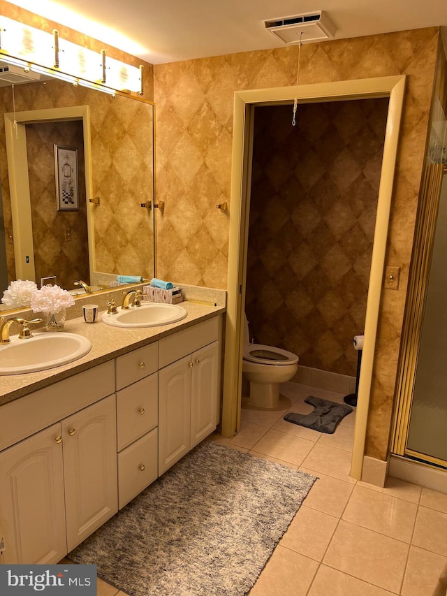 bathroom featuring vanity, toilet, and tile patterned floors