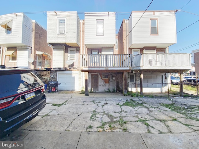 townhome / multi-family property with a balcony and a garage