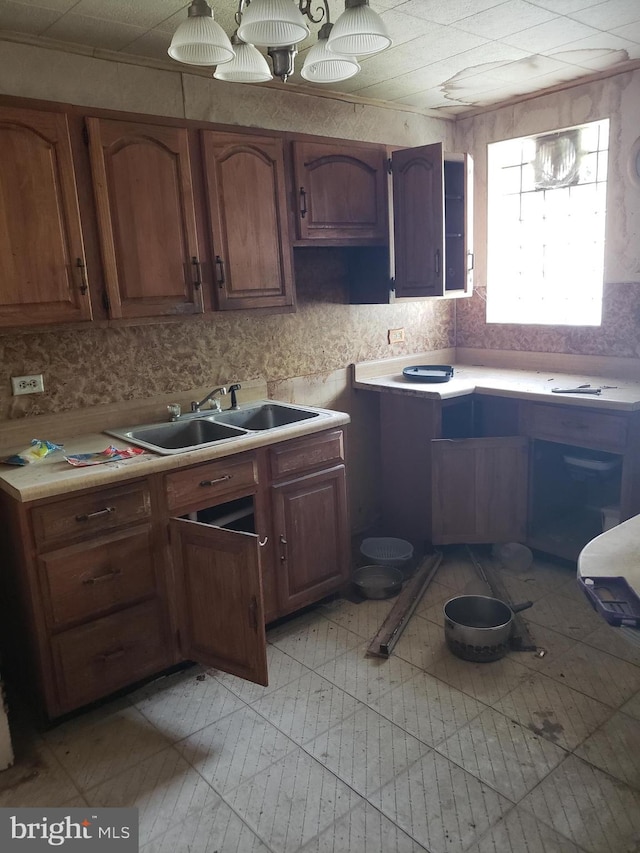 5348 Westford Rd, Philadelphia, PA 19120 - kitchen with a sink, light countertops, and brown cabinetry